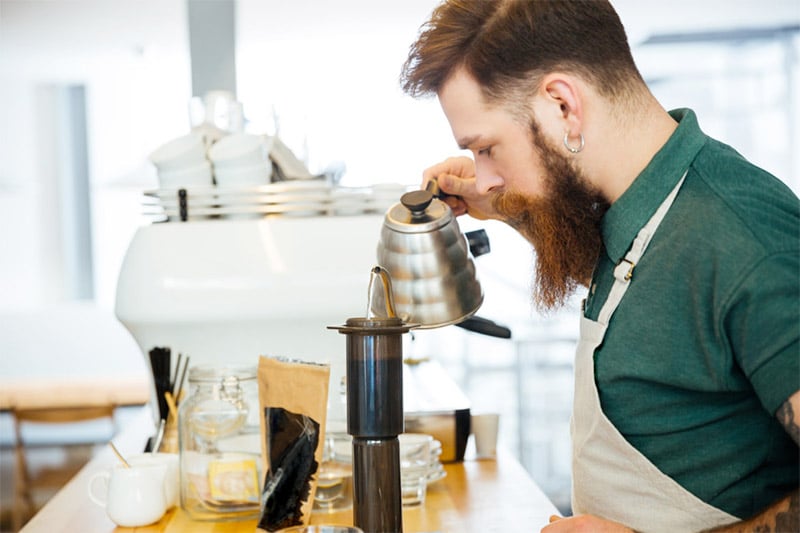 barista using a gooseneck kettle